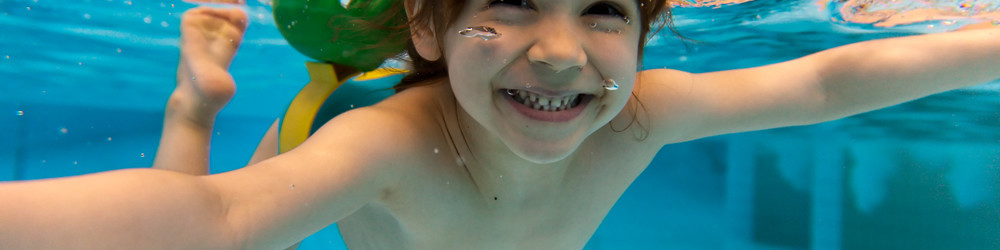 Child Enjoying Swimming in Pool